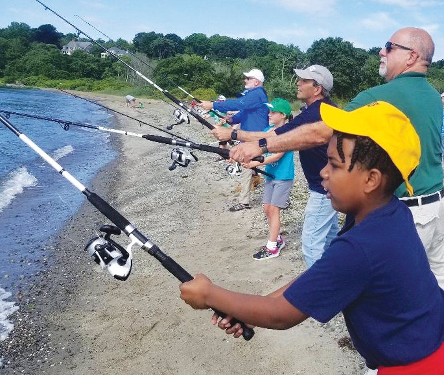 FISHING CAMP FIRST CAST: Camper Kayden King, Providence (foreground); Terrance Gray, DEM Director; Mayor Frank Picozzi, Warwick; and in background Greg Vespe, Executive Director, RISAA. (Submitted photos)